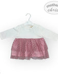 White shirt with pink skirt on a hanger against a white background, branded 'Mother's Choice'.