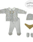 Baby clothing set with top, pants, hat, and booties on a white background