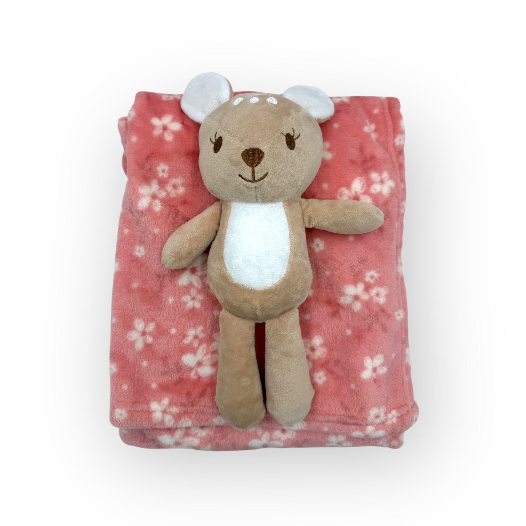 Plush bear toy on a pink floral blanket with a white background