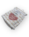 Baby blanket with 'love you' heart tag on a white background