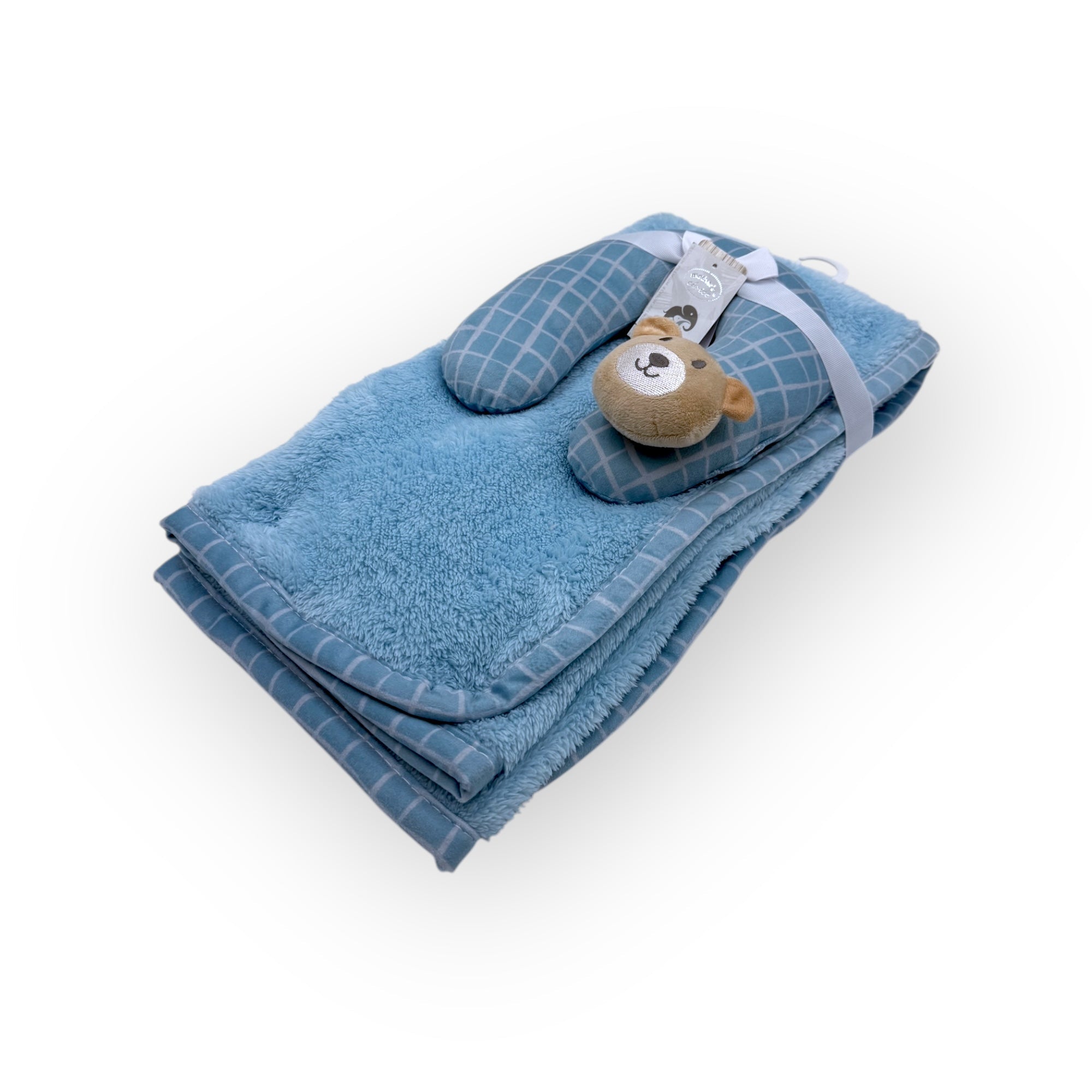 Folded blue towel with a teddy bear toy on a white background