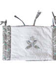 Baby crib bumper with dragonfly design on a white background