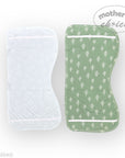 Green baby bib with white leaf pattern and clear plastic bag on a white background