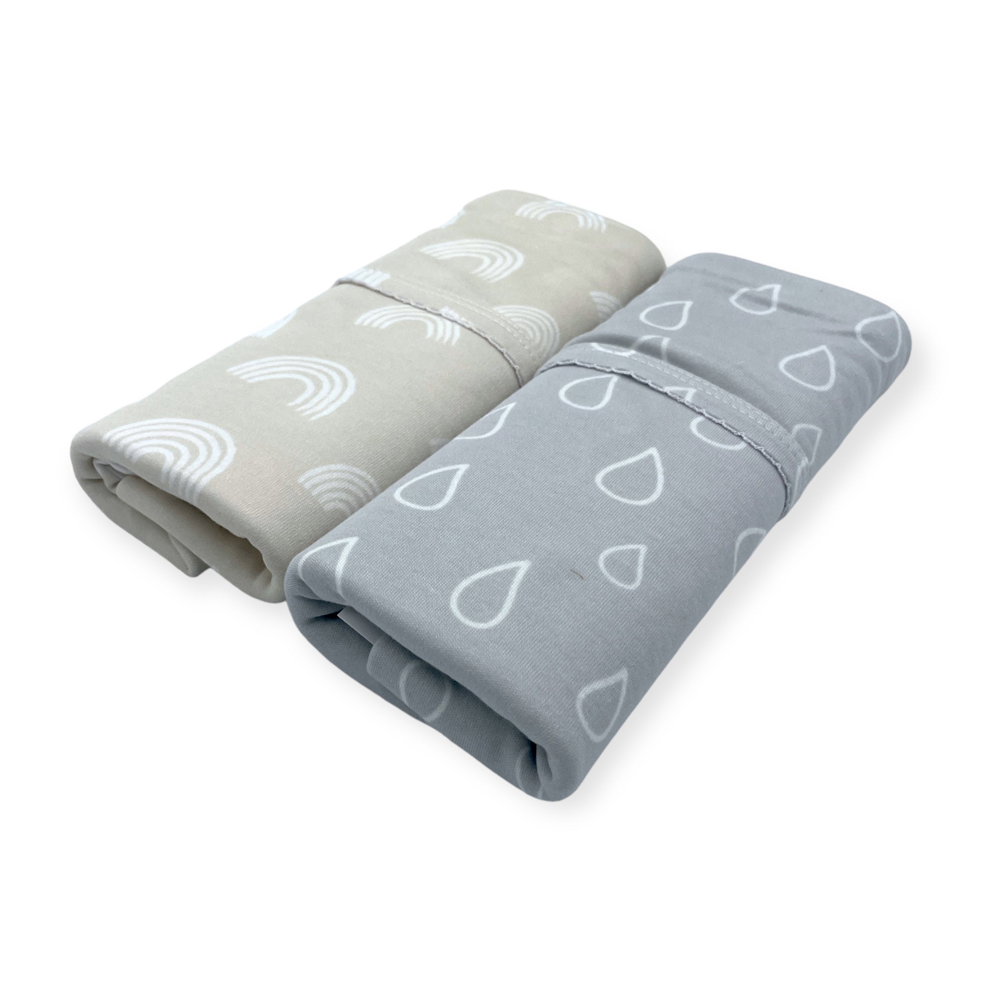 Two folded blankets with patterned designs on a white background