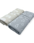 Two folded blankets with patterned designs on a white background