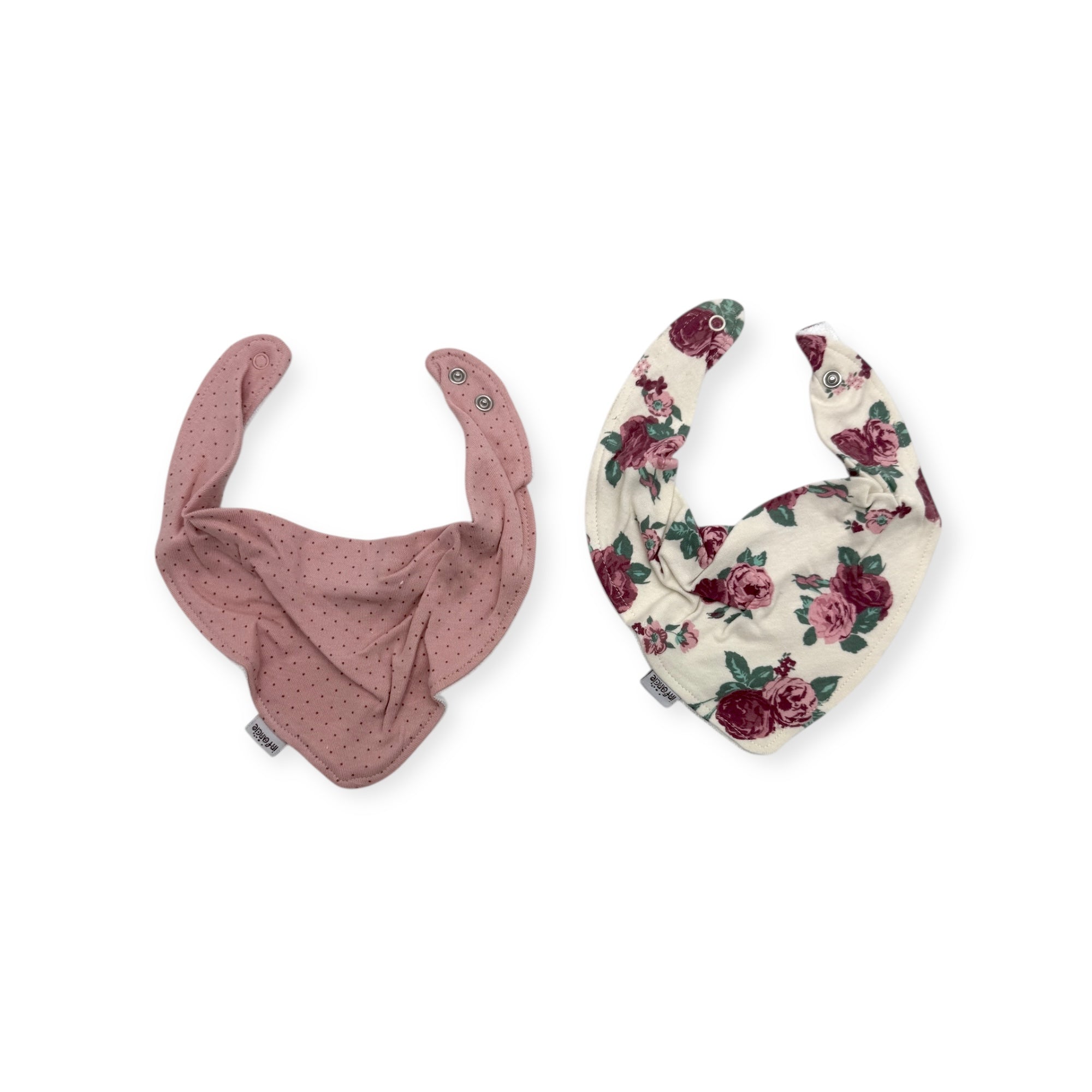 Two baby bibs, one pink with subtle pattern and one floral, on a white background.