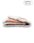 Stack of pink and white blankets with 'mother's choice' branding on a white background