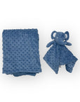 Blue textured blanket and elephant-shaped toy on a white background