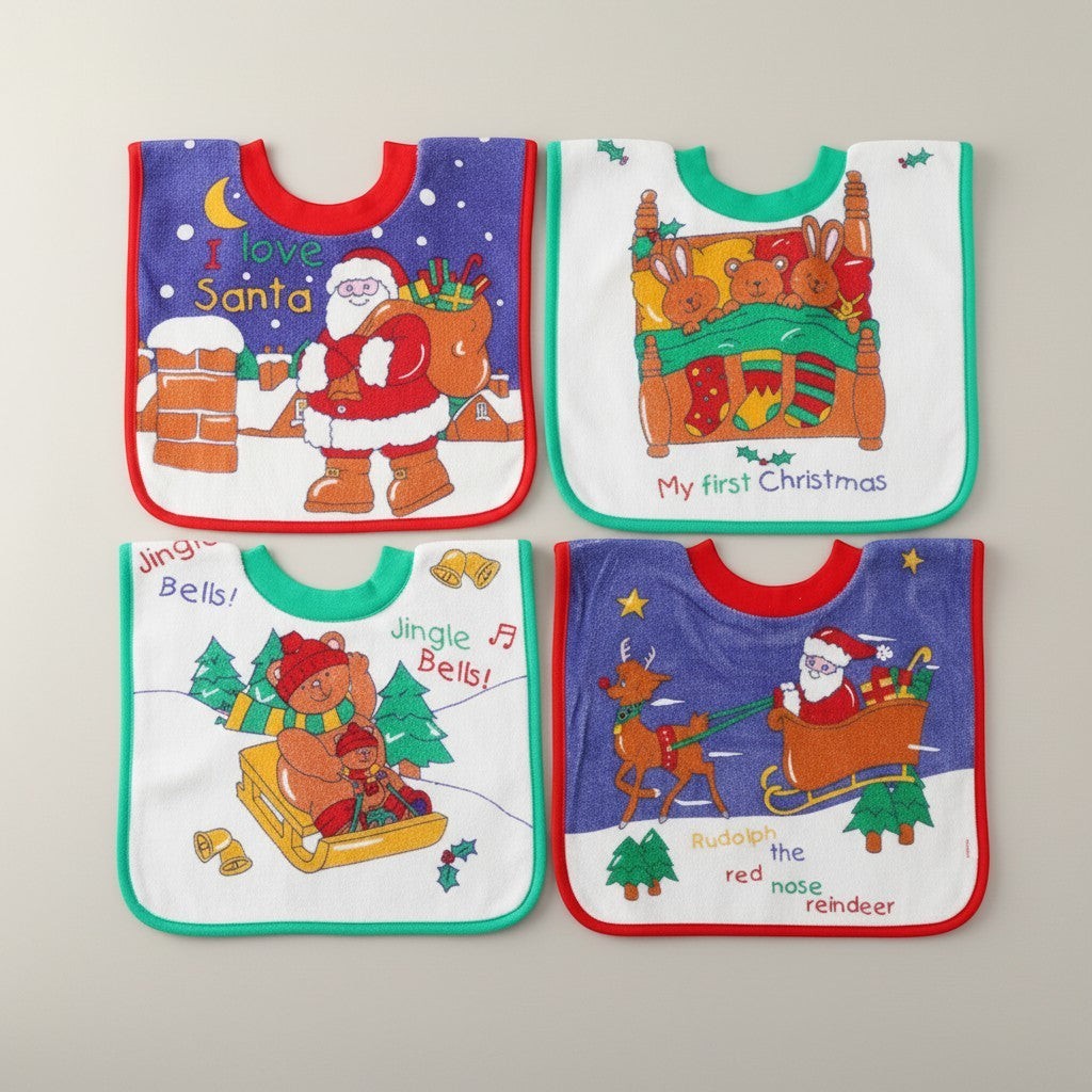 Four Christmas-themed baby bibs on a light gray background