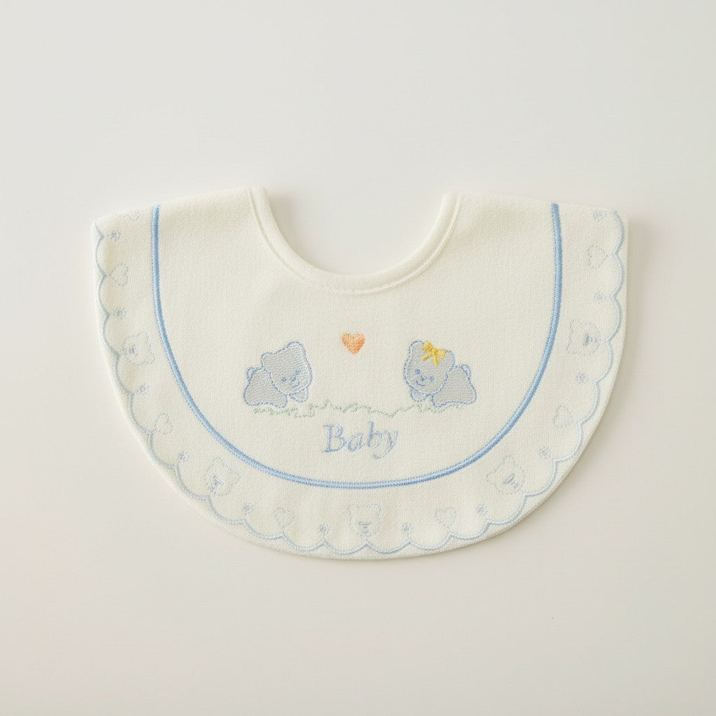 Baby bib with teddy bear design and 'Baby' text on a light background