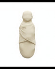 Beige baby swaddle with brand logo on a white background