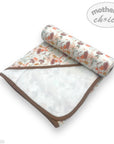 Baby blanket with floral pattern and brown border on a white background, featuring 'Mother's Choice' branding.