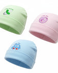 Three baby hats in green, pink, and blue with embroidered designs on a white background.