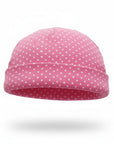 Pink beanie with white polka dots on a white background