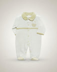 White baby onesie with green accents on a light gray background