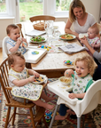 Family with children eating at a dining table in a home setting
