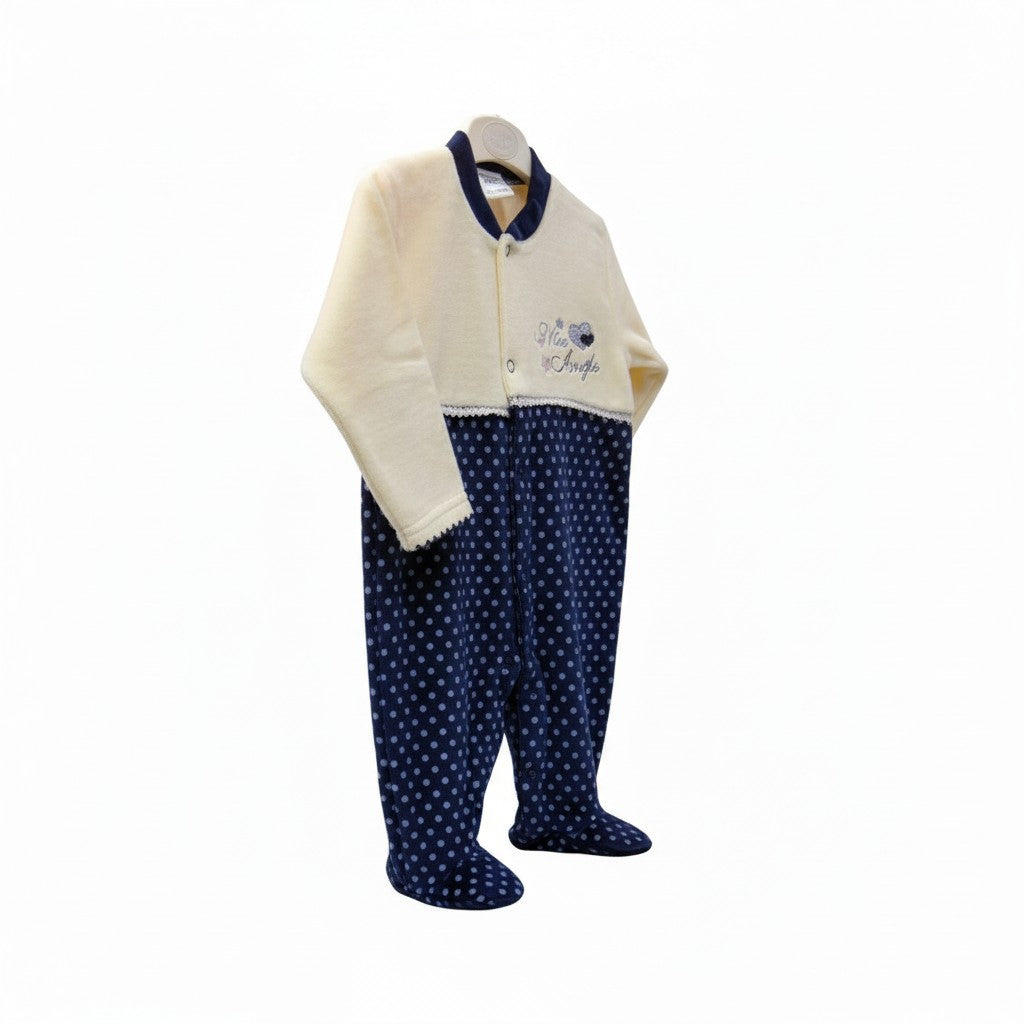Children's outfit with a cream cardigan and navy polka dot pants on a white background