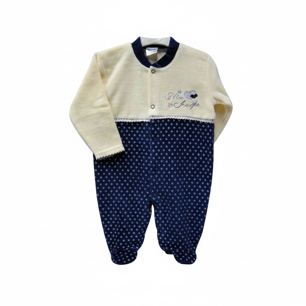 Baby onesie with cream top and navy polka dot bottom on a white background
