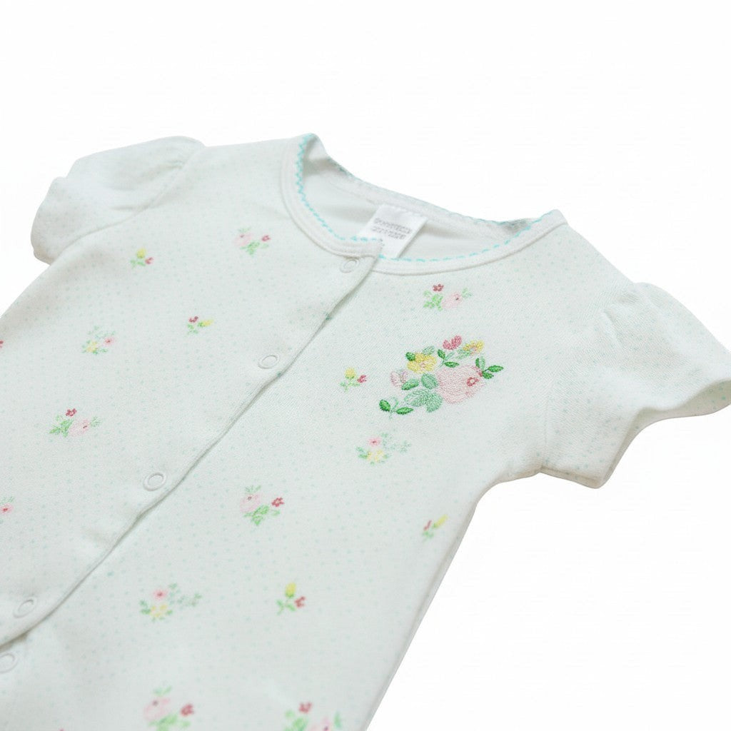 Baby romper with floral embroidery on a white background