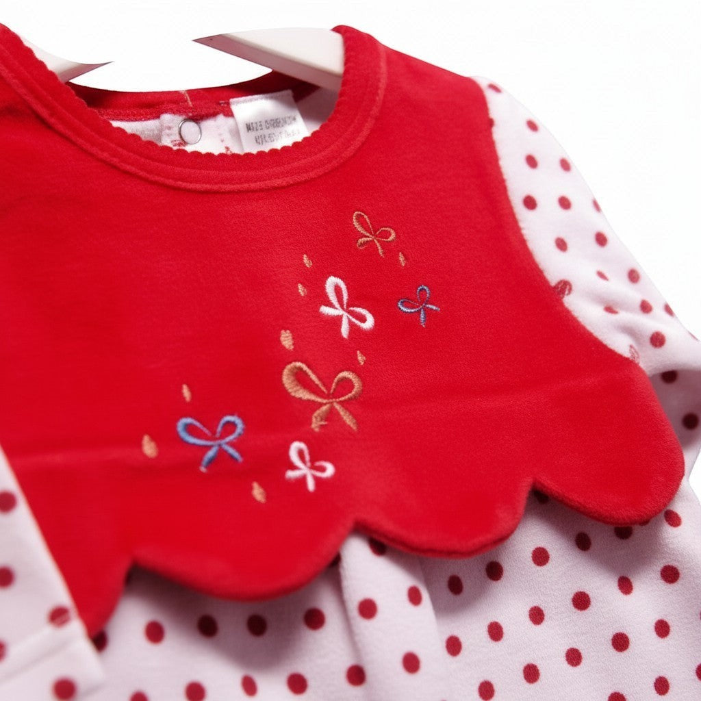 Red bib with embroidered bows on a white background