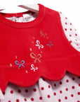 Red bib with embroidered bows on a white background