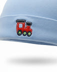 Light blue baby hat with a red train design on a white background