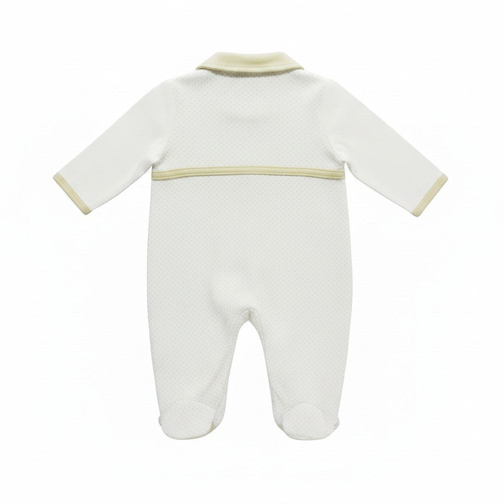 White baby onesie with beige trim on a white background