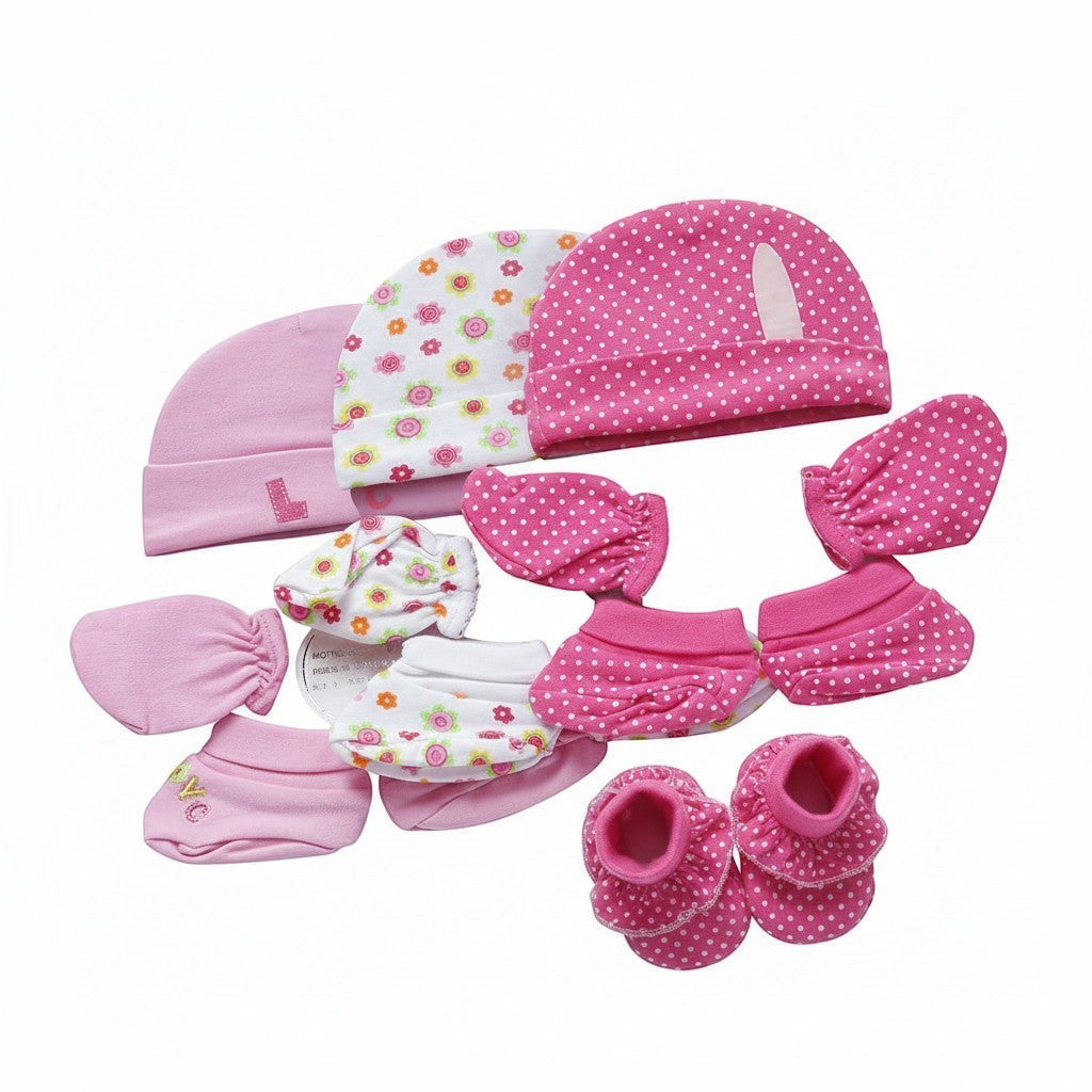 Collection of pink baby accessories including hats, mittens, and booties on a white background