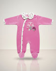 Pink baby onesie with mushroom design on a light gray background