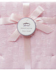 Pink textured blanket with a bow and 'mother's choice' label on a white background