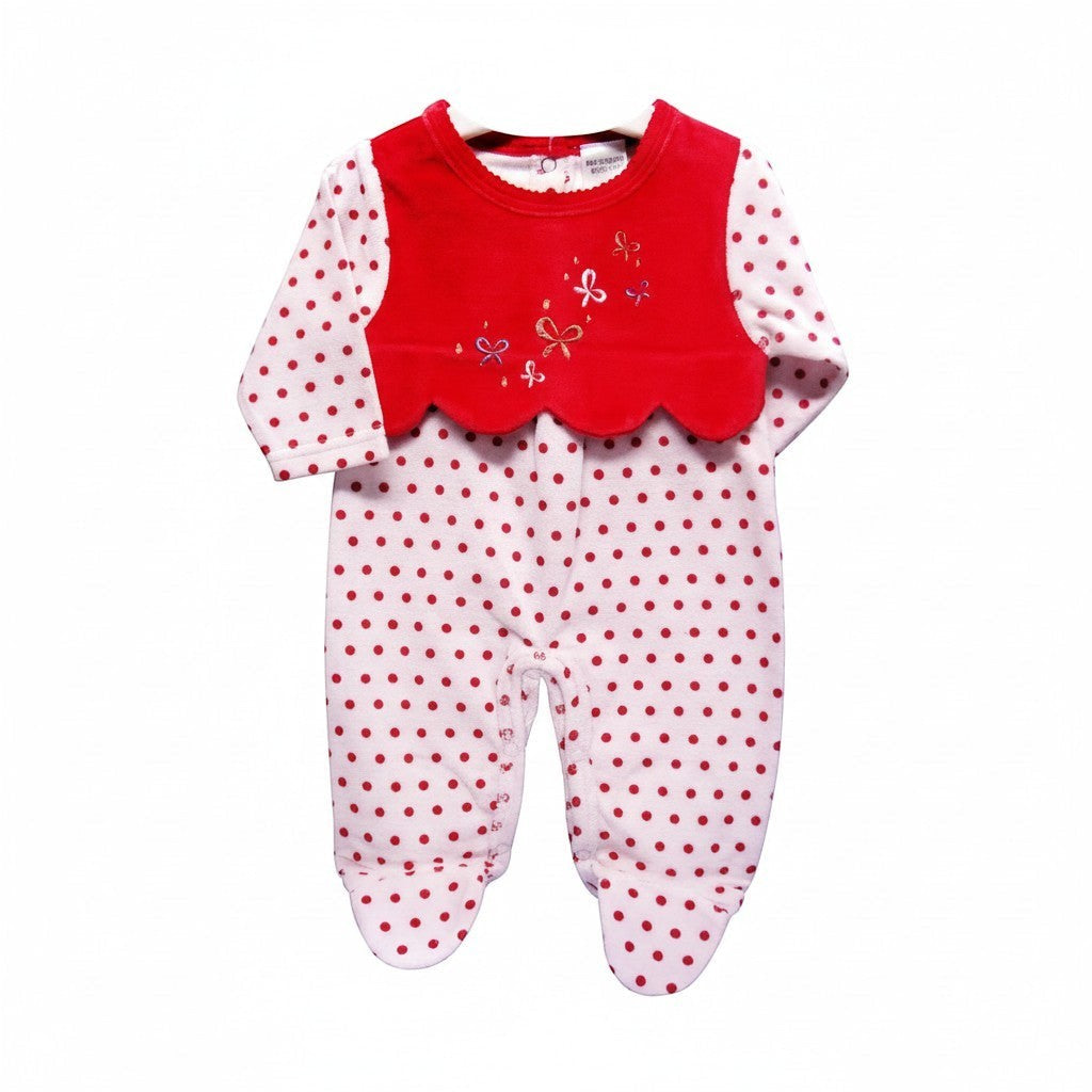 Baby romper with red top and white polka dot pants on a white background