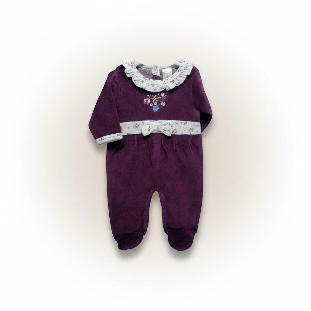 Purple baby romper with floral embroidery on a beige background