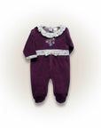 Purple baby romper with floral embroidery on a beige background