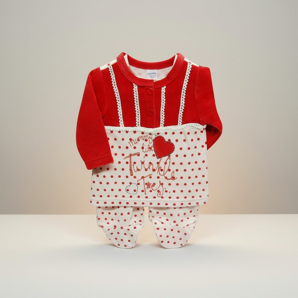 Red and white baby outfit with polka dot pattern on a neutral background