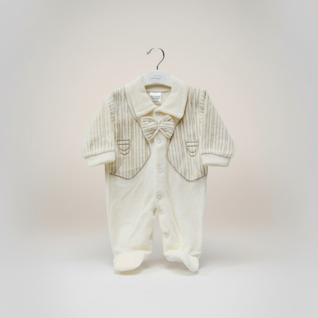 Baby outfit with jacket and pants on a hanger against a light background
