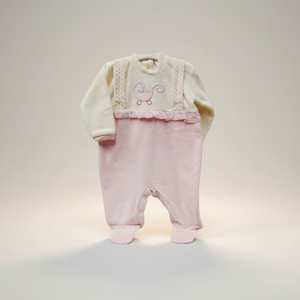 Baby outfit with pink pants and cream sweater on a light background