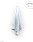 Light blue towel hanging on a white wall with 'mother's choice' branding.
