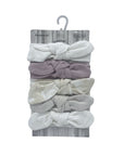 Set of baby headbands on a wooden hanger with 'Babbles' branding.