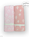 Two pink baby blankets with white patterns on a white background, branded 'Mother's Choice'.