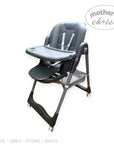 Gray high chair with tray on a white background, featuring 'Mother's Choice' branding.