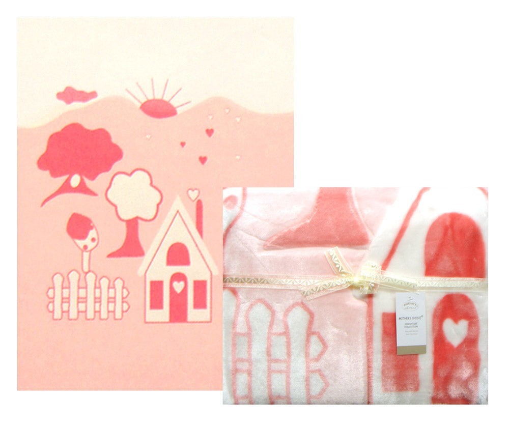 Pink children's blanket with house and tree design on a white background