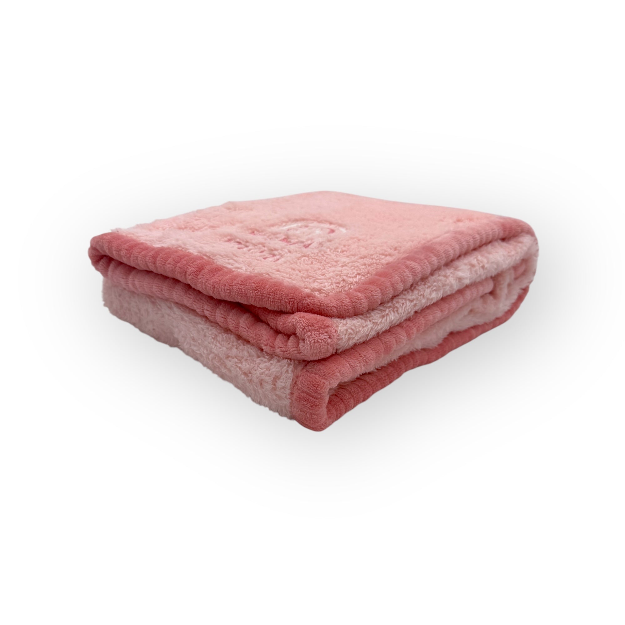 Folded pink blanket on a white background