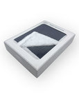 Baby blanket in a gray box on a white background