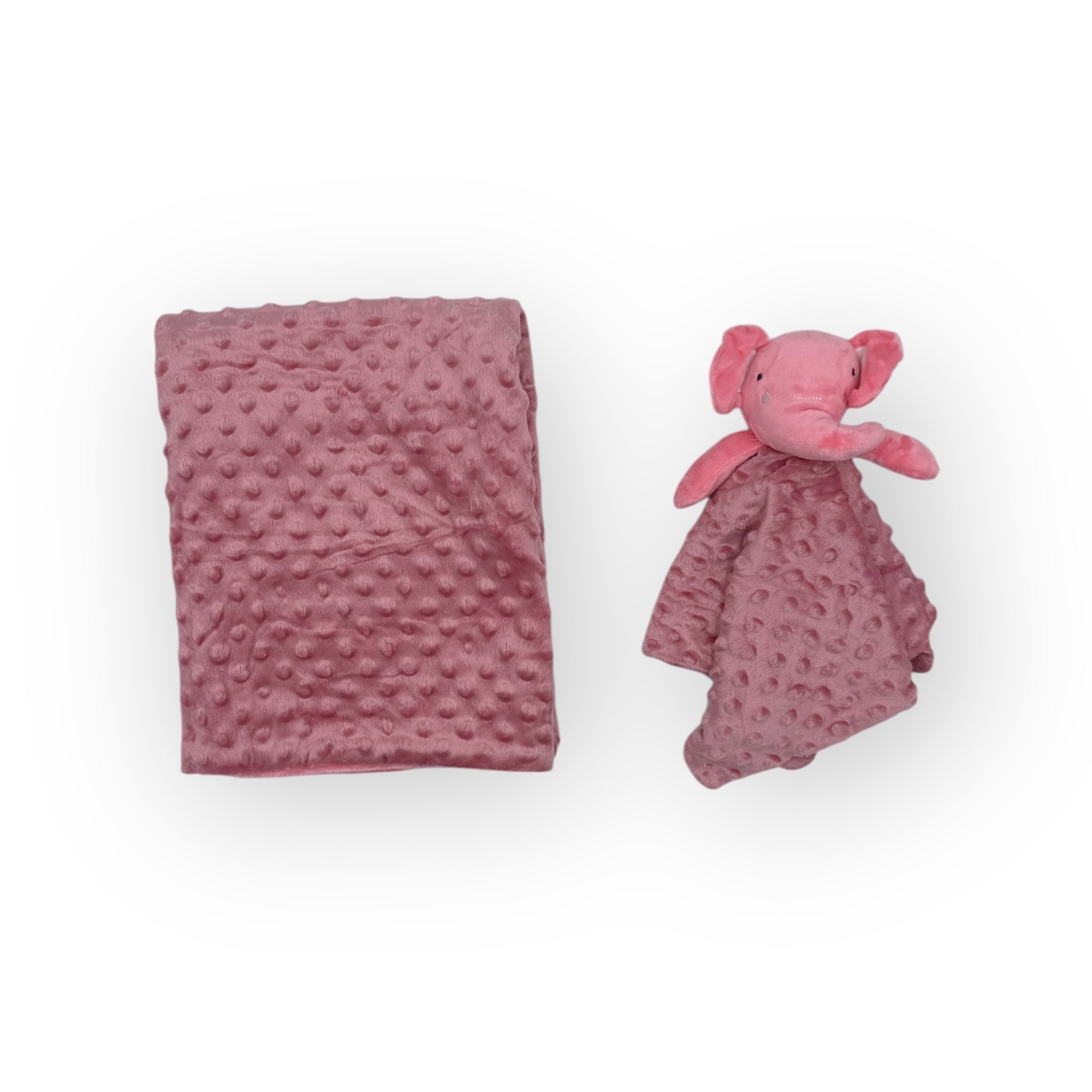 Pink textured blanket and plush elephant toy on a white background