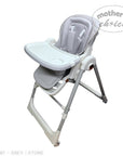 Gray high chair with tray on a white background, featuring 'Mother's Choice' branding.