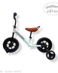 Children's balance bike with black wheels and white frame on a white background, branded 'Mother's Choice'.