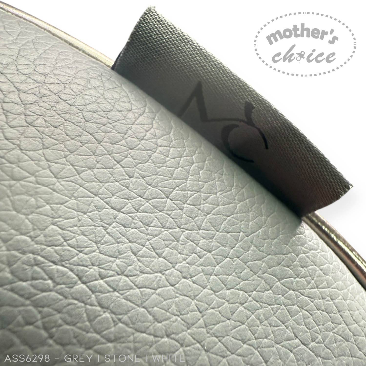 Close-up of a textured fabric with 'mother's choice' branding on a light gray background.