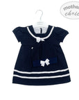 Navy blue dress with white trim on a hanger against a white background, featuring 'Mother's Choice' branding.