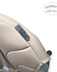 Close-up of a beige stroller seat with a 'mother's choice' label on a white background.