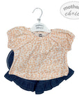 Children's outfit with floral top and denim skirt on a 'Mother's Choice' hanger.